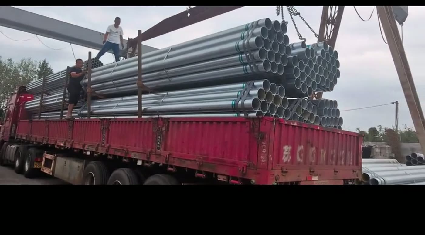 Galvanized pipes loaded on the truck with straps secured